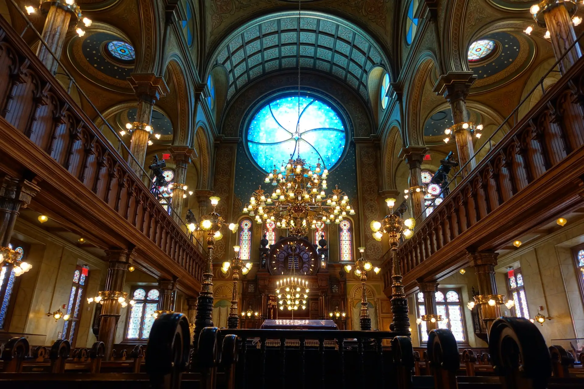 Restored sanctuary of the Eldridge Street Synagogue with its round east window and brass chandeliers, Lower East Side