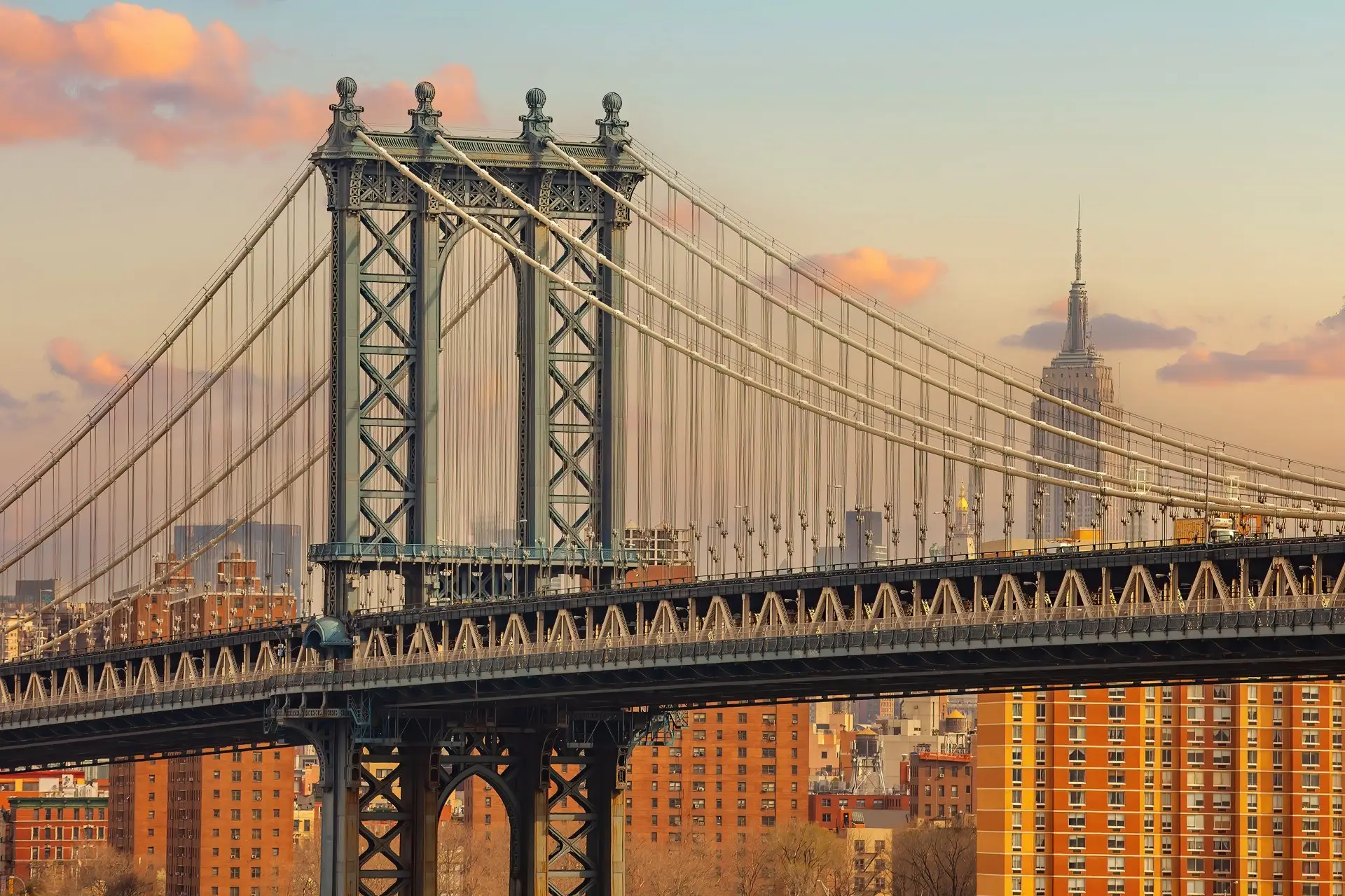Manhattan Bridge towers and cables with the Empire State Building in the distance, New York City